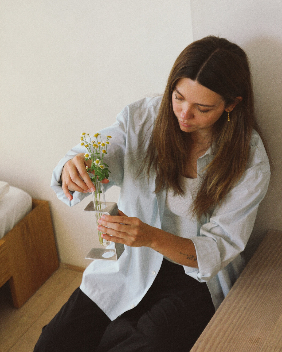 Isabella Farrell, Danish industrial designer, holding the Stem vase she designed for Dialekt Objects