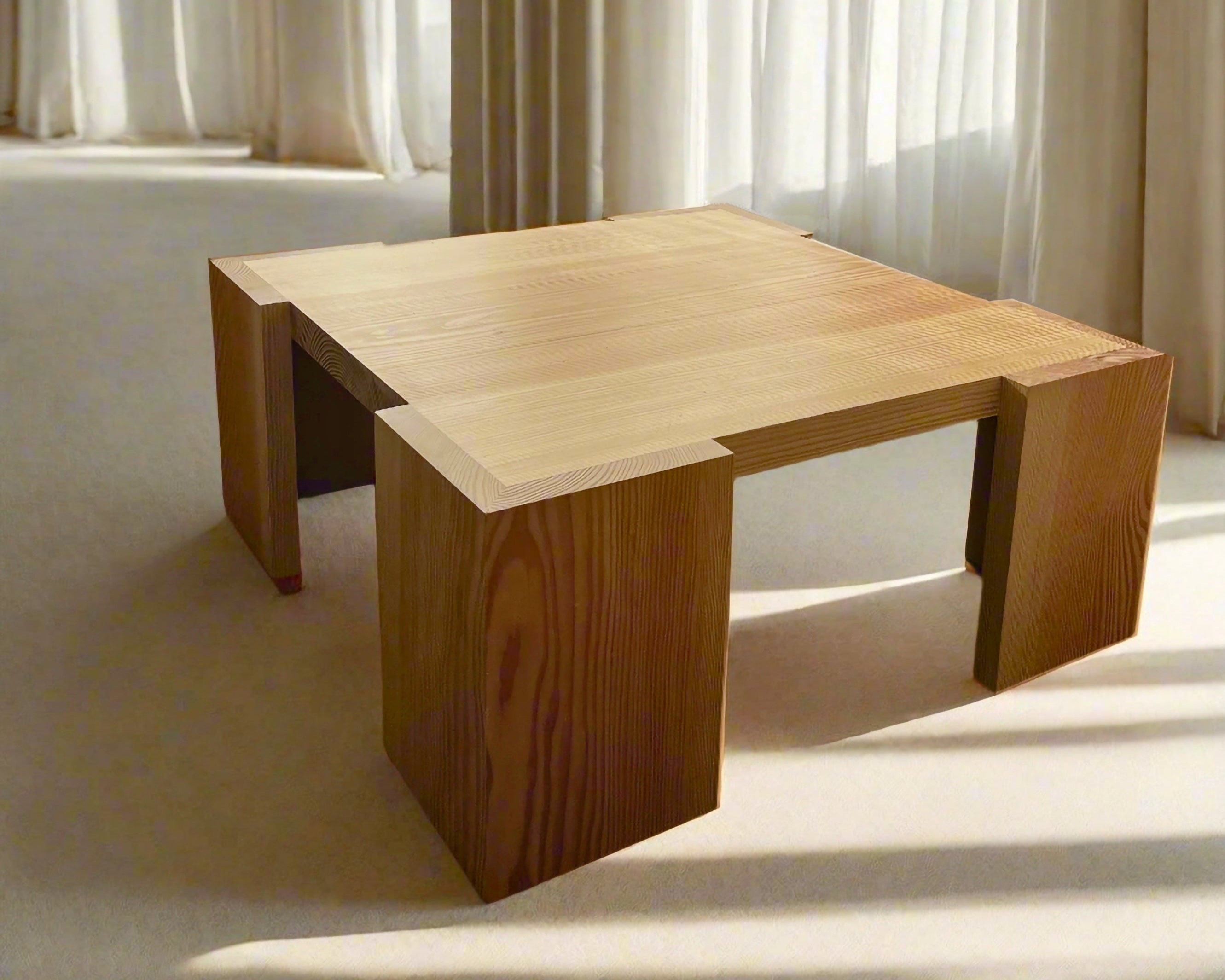Wooden coffee table in a room with light curtains