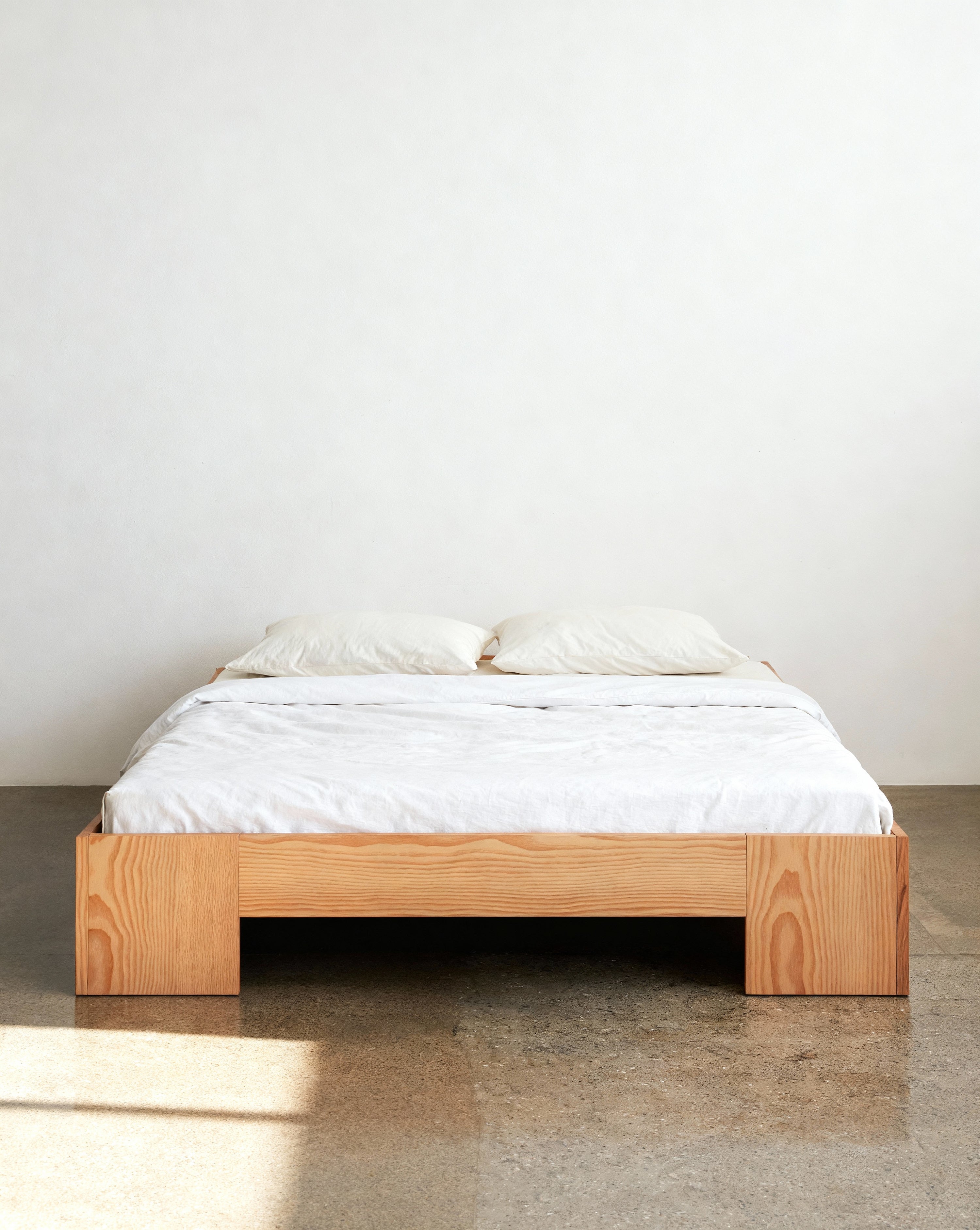 Tunnel Bed Frame in Douglas fir shown in a soft-toned bedroom