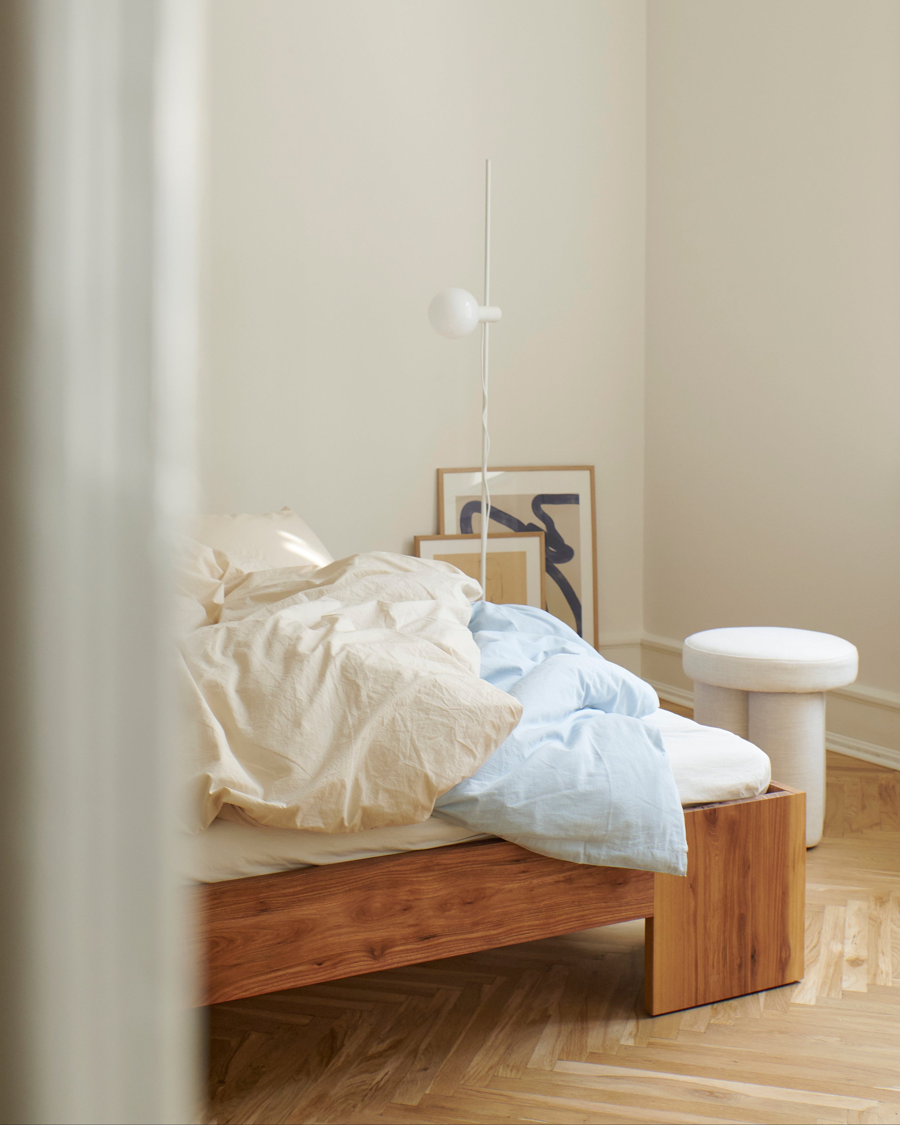 Tunnel Bed Frame in elm styled in a minimal bedroom setting