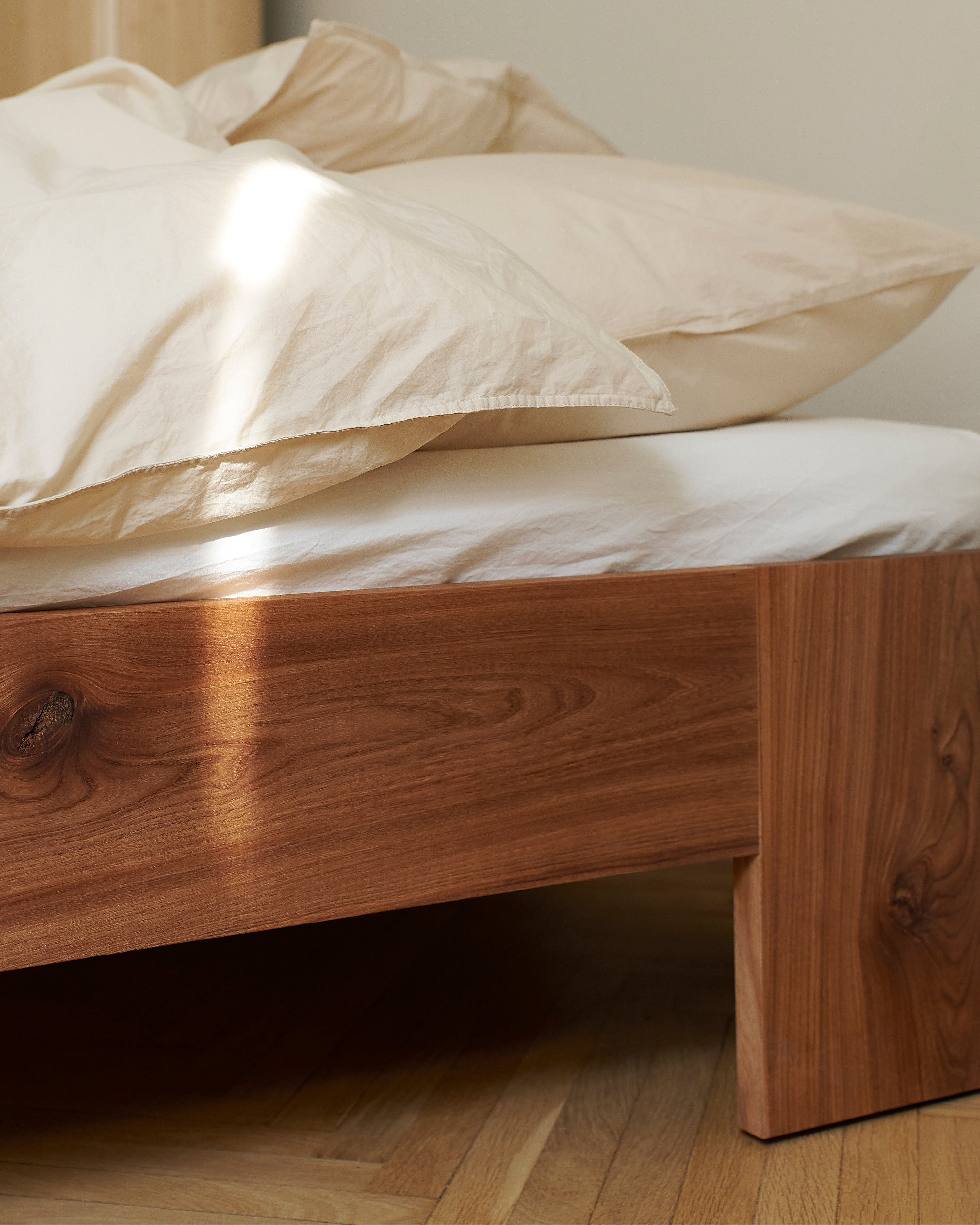 Tunnel Bed Frame in elm styled in a minimal bedroom setting